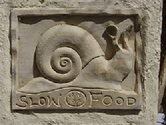 A restaurant placard in Santorini, Greece, depicting the snail logo of the international Slow Food movement.